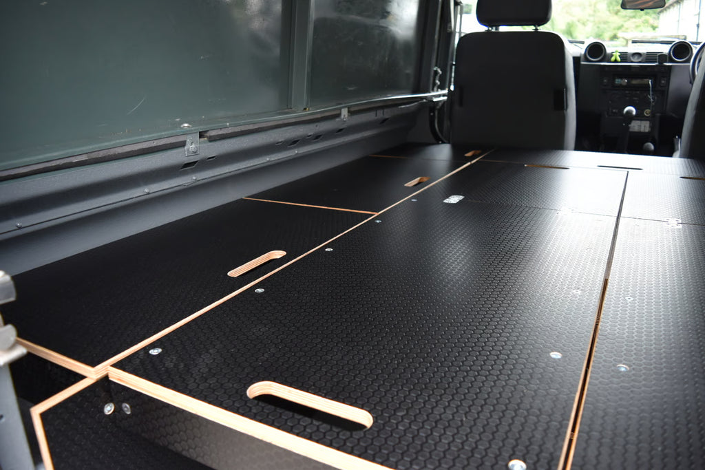 Black wooden bed platform as featured in the Hexamoto Defender Easy Sleeper 