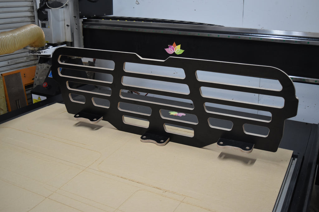 Black wooden dog guard sat on a CNC bed