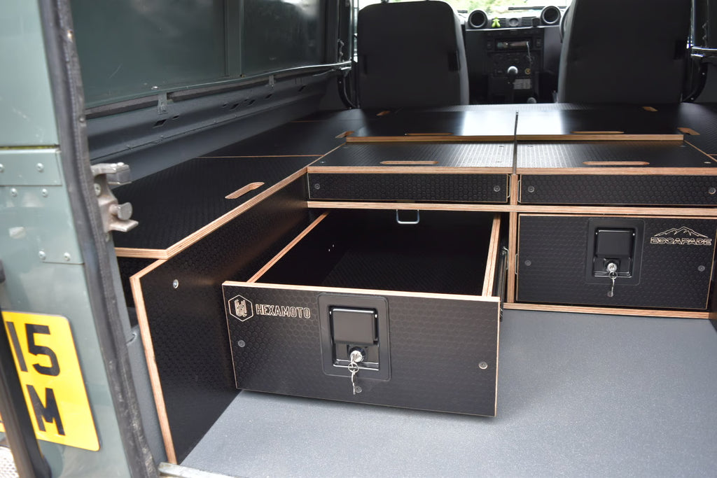 Storage compartments and drawer in Defender 110 with system also providing a sleeping solution