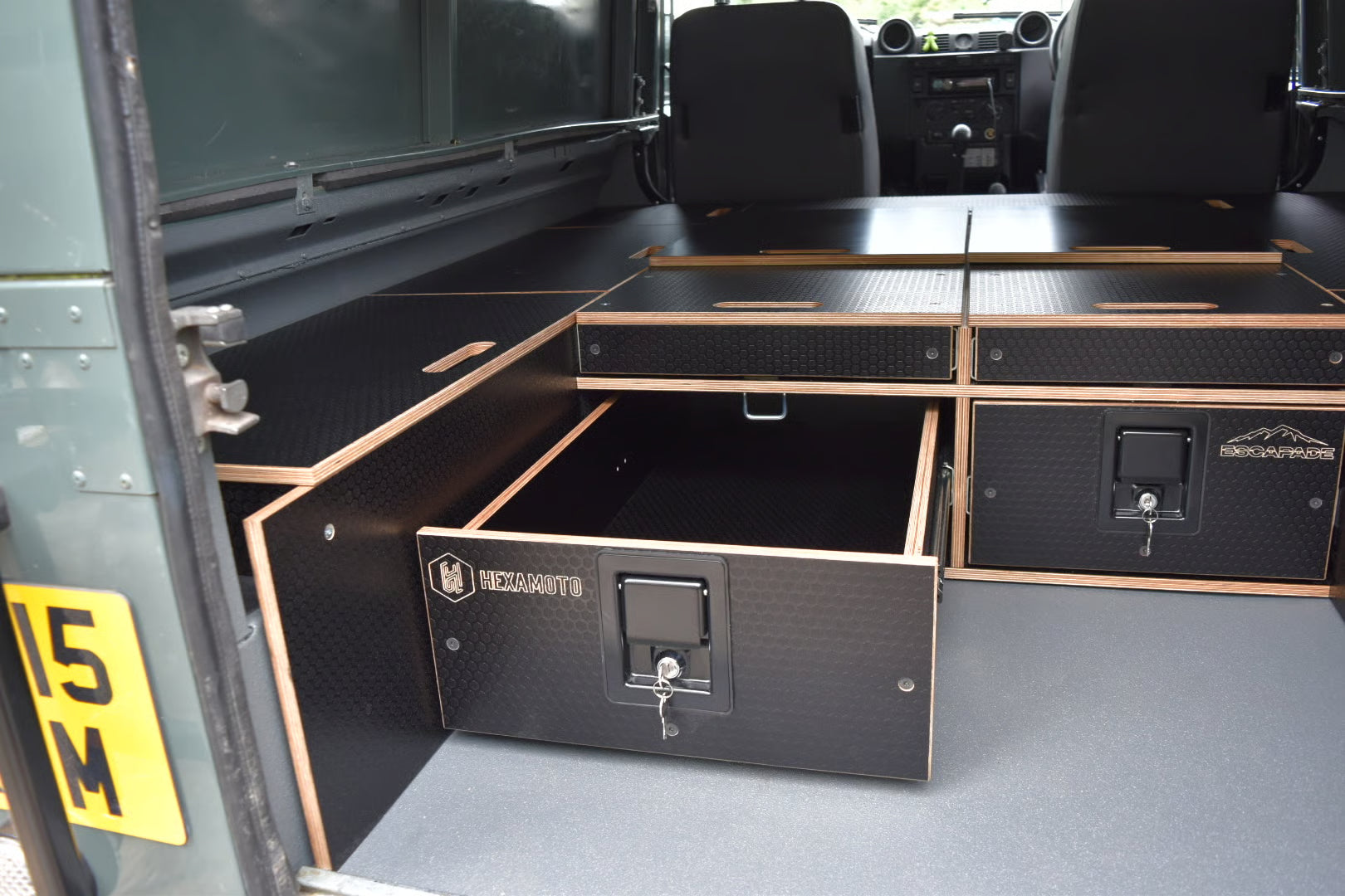 Storage compartments and drawer in Defender 110 with system also providing a sleeping solution