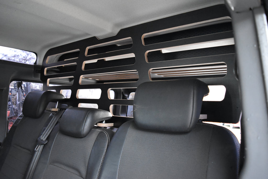 Black leather seats inside a vehicle with a wooden Dog Guard from Hexamoto