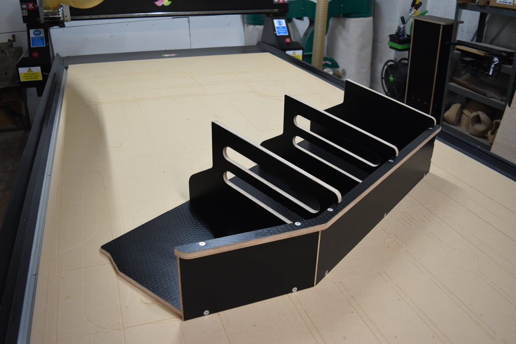 Black wooden storage system on a CNC bed