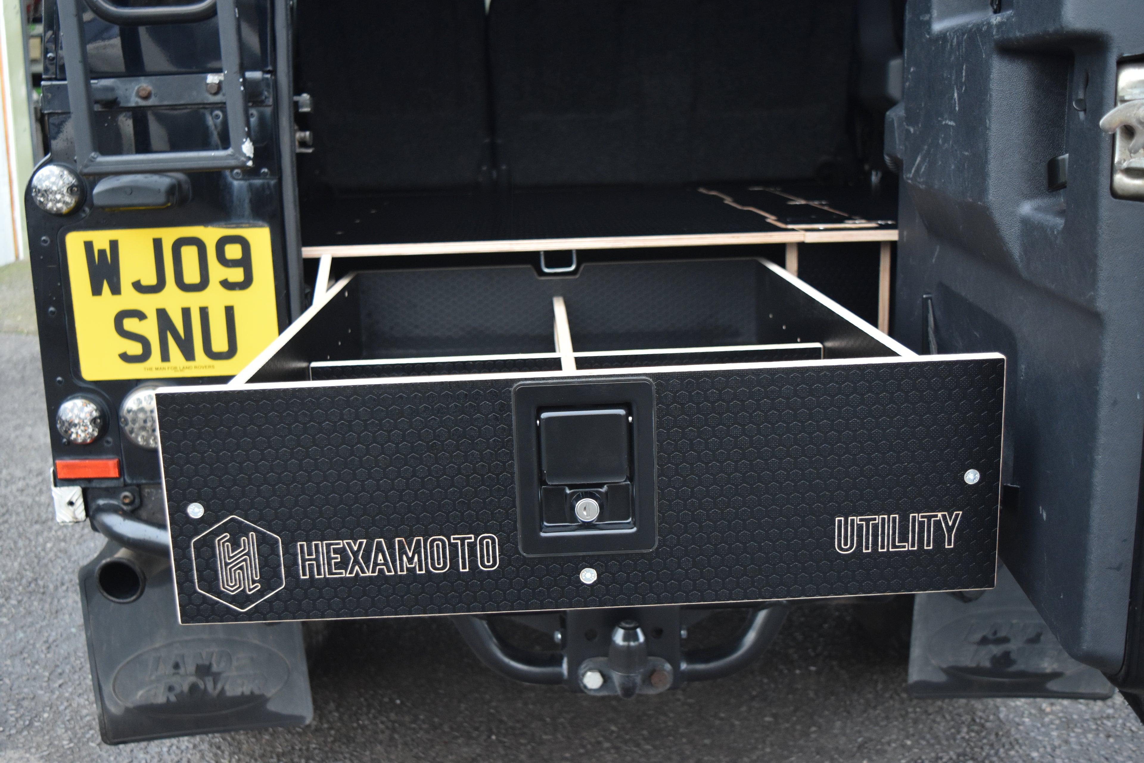 Hexamoto Utility storage drawer attached to a vehicle with drawer open