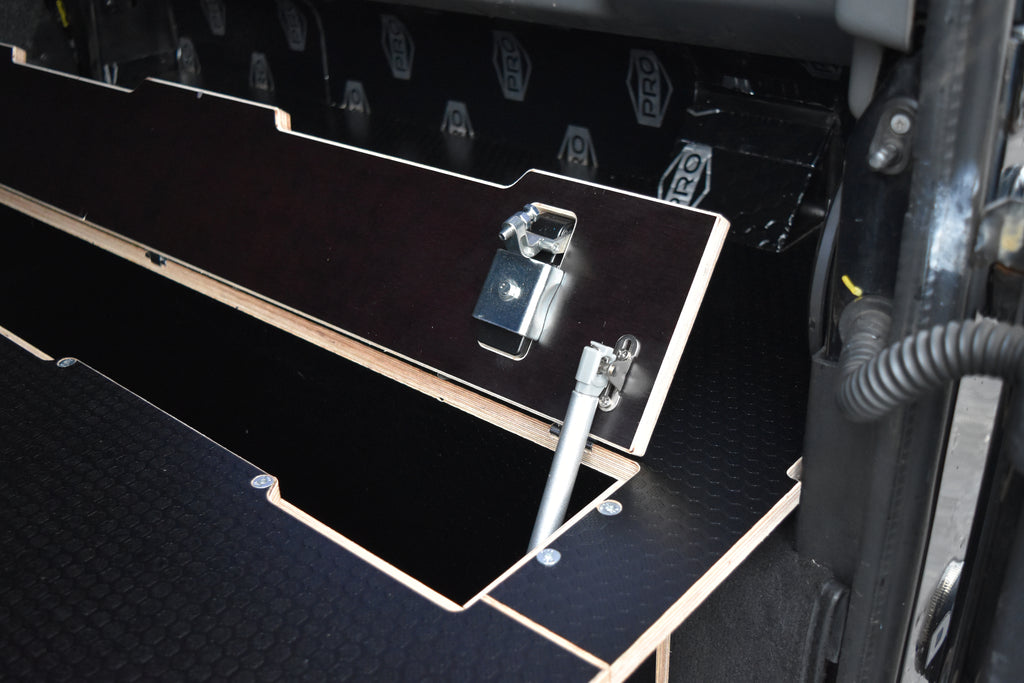 Close up of the components used to lock and open the Utility cubby hole
