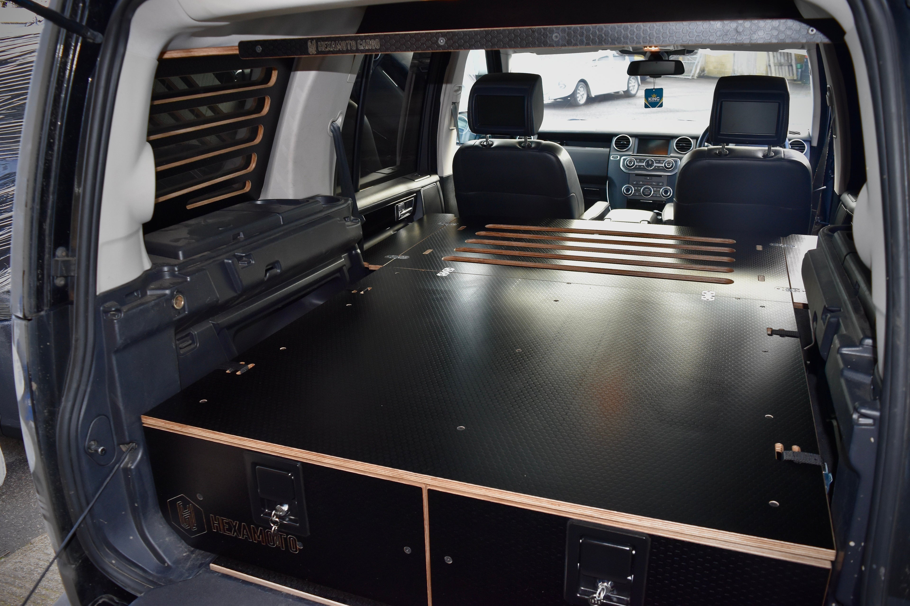 Car interior with drawer system and sleeping platform