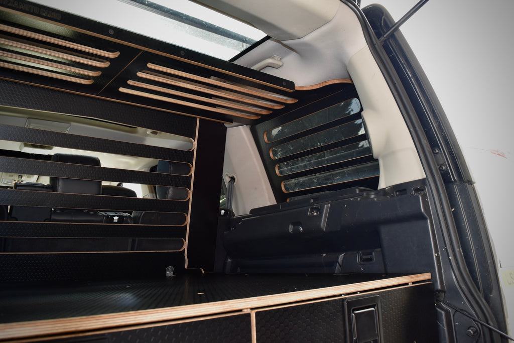 Car interior with overhead storage racks and drawer system 