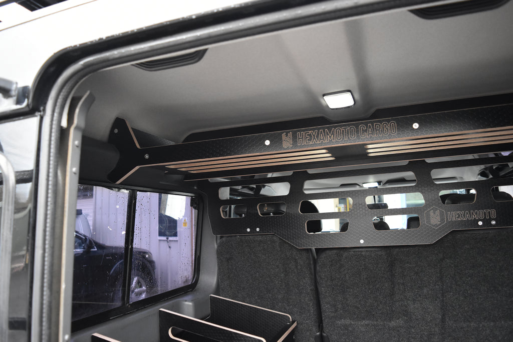Interior of a vehicle with a cargo area and 'Hexamoto' branding on Dog Guard and Cargo system