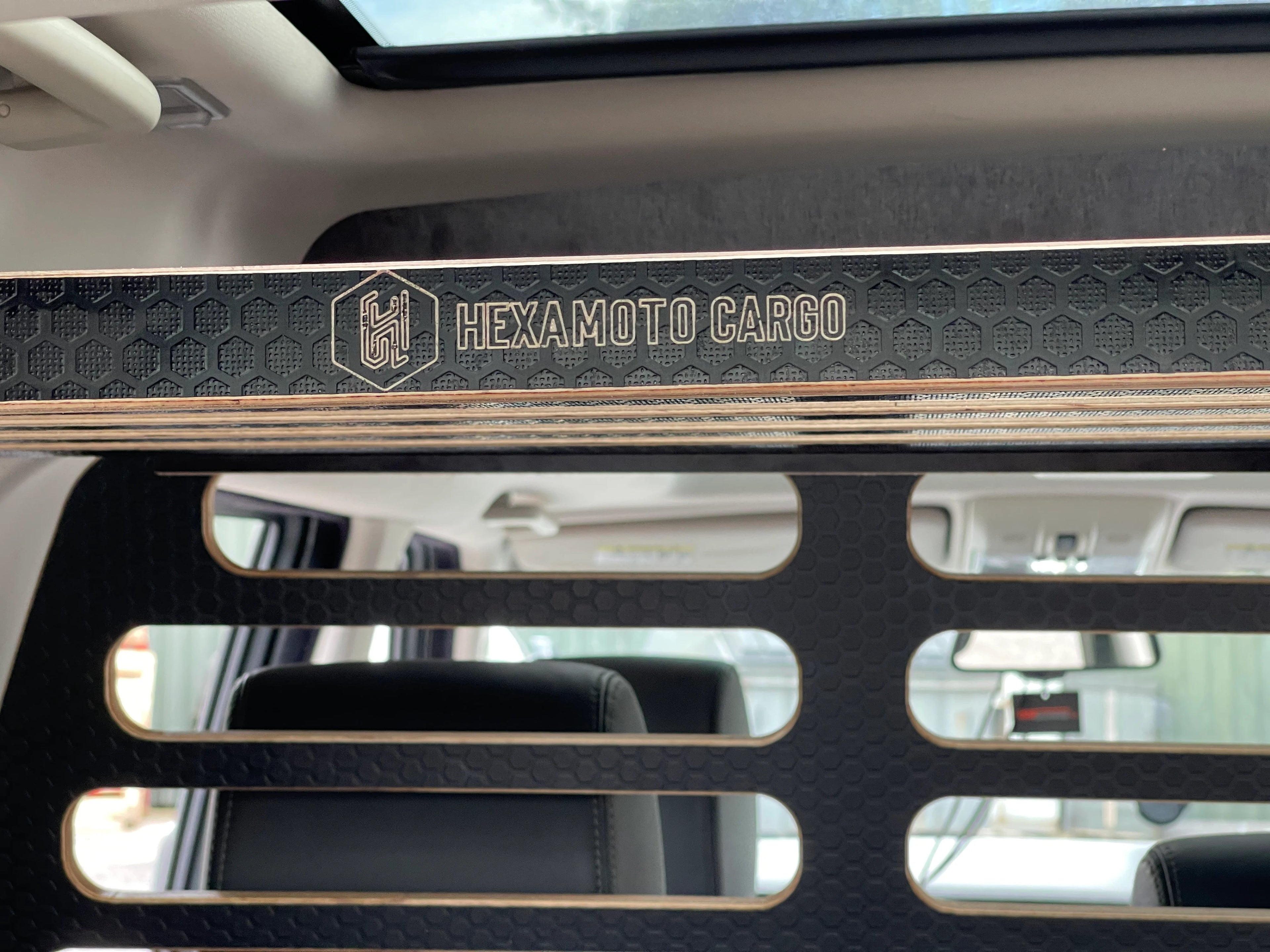 Hexamoto Cargo storage system with brand logo, inside a vehicle