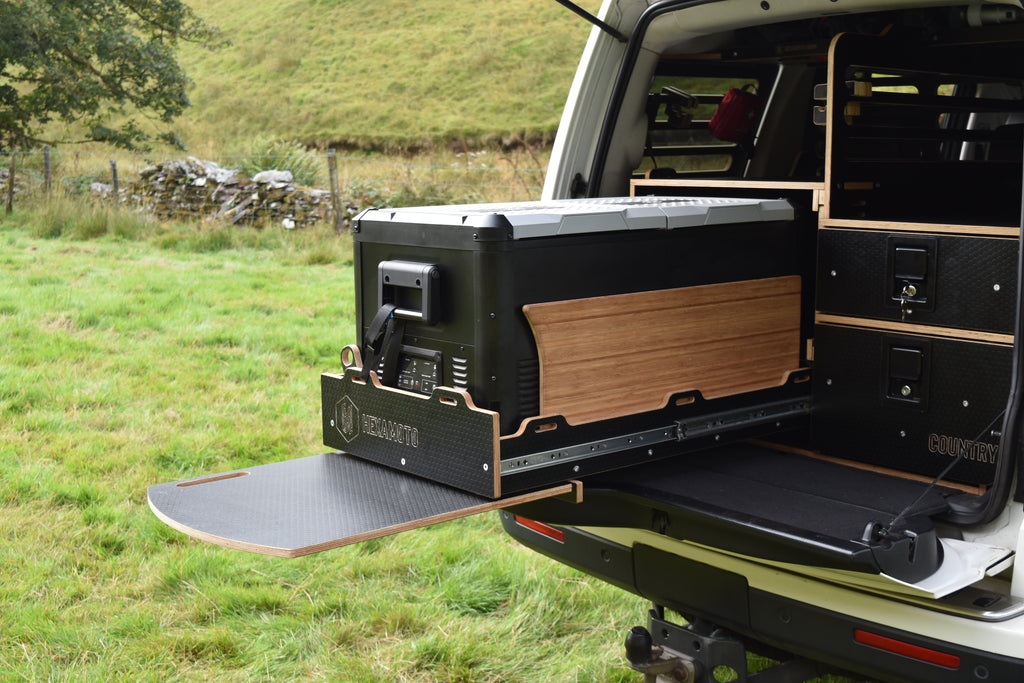 Truck with an open storage unit in a grassy field