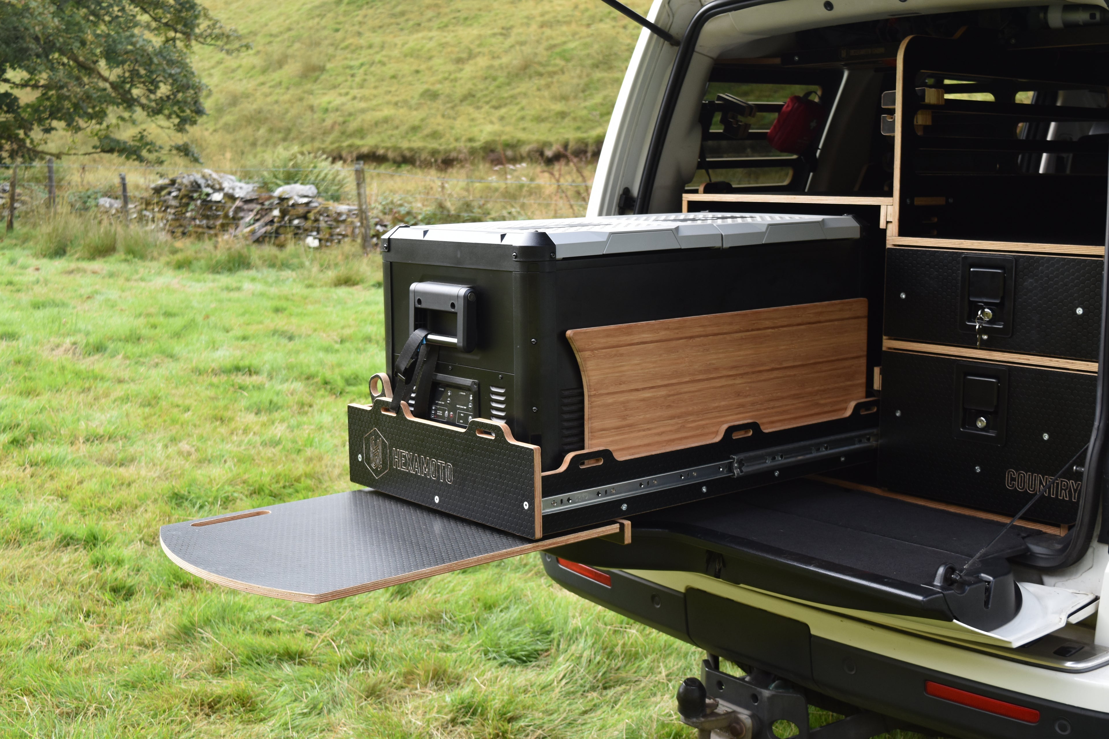 Truck with an open storage unit in a grassy field