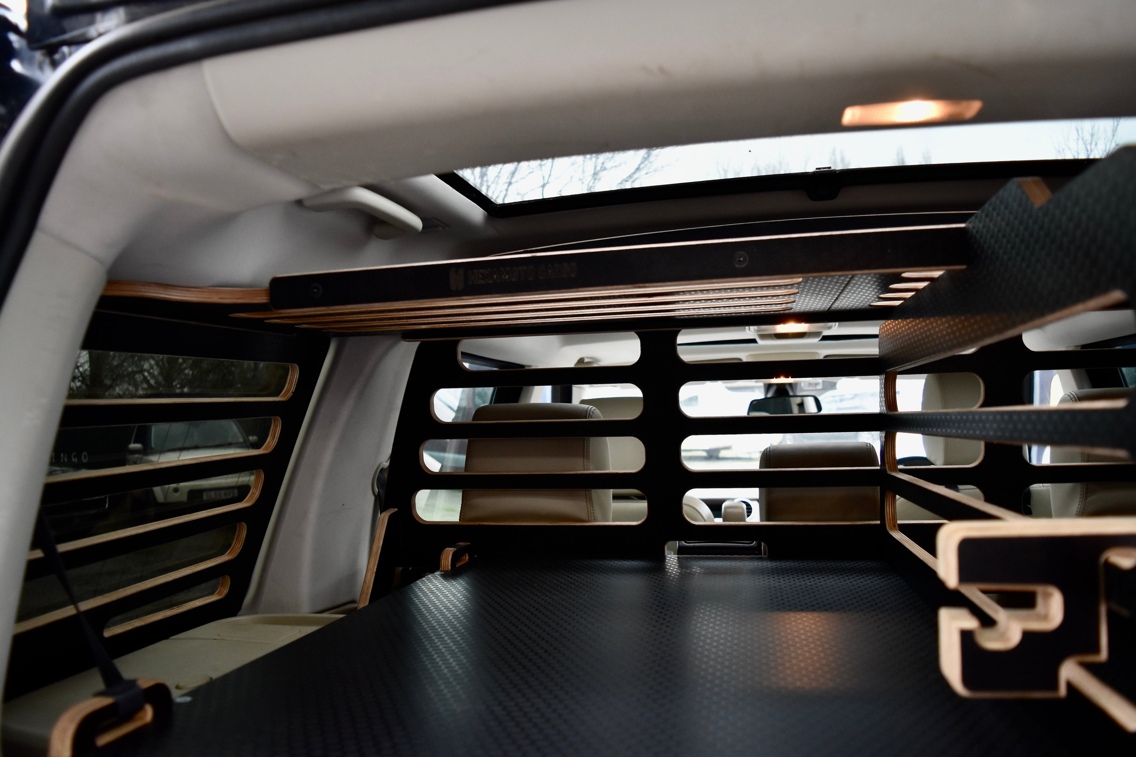 Car interior with a view of the storage system and overhead storage Cargo