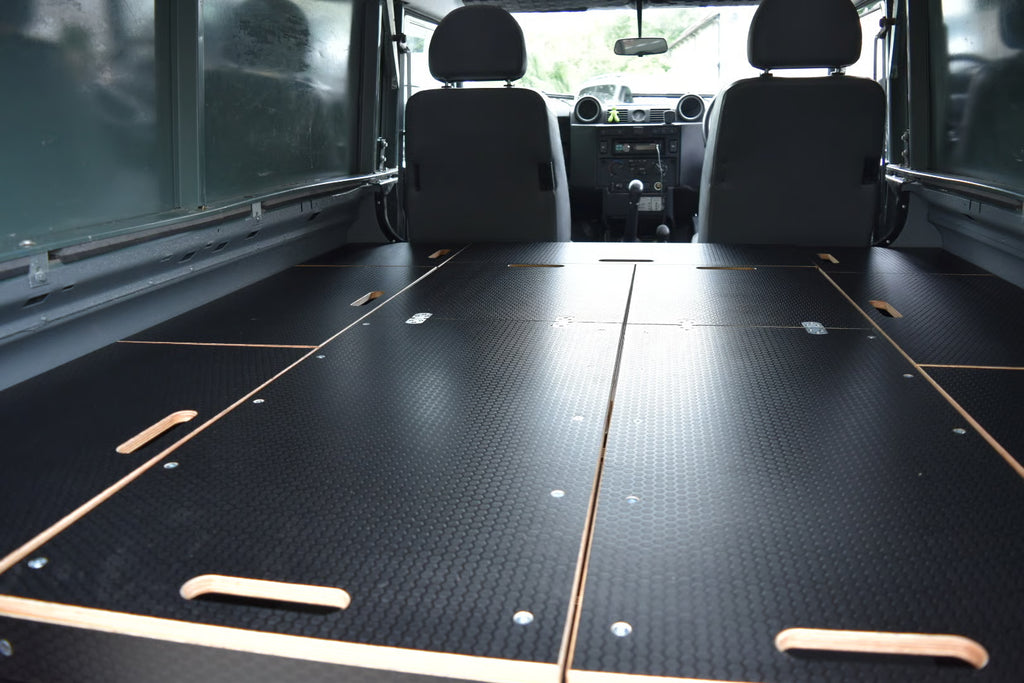 Defender Interior with flat sleeping platform and storage cupboards