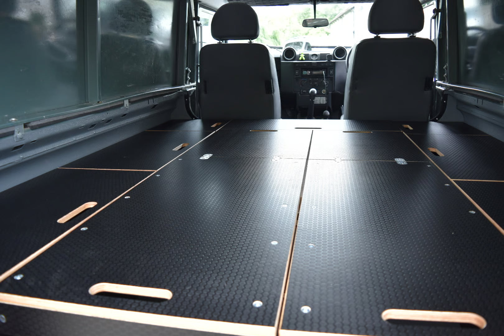 Defender Interior with flat sleeping platform and storage cupboards