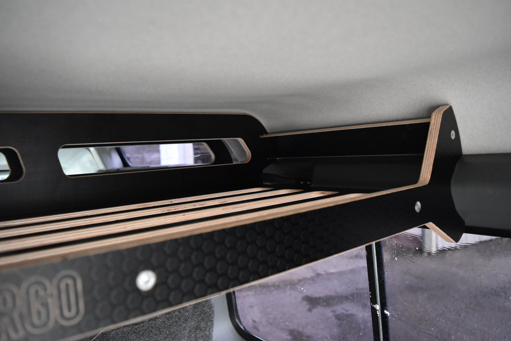 Black wooden storage system to fit overhead in a Defender 110 Stationwagon