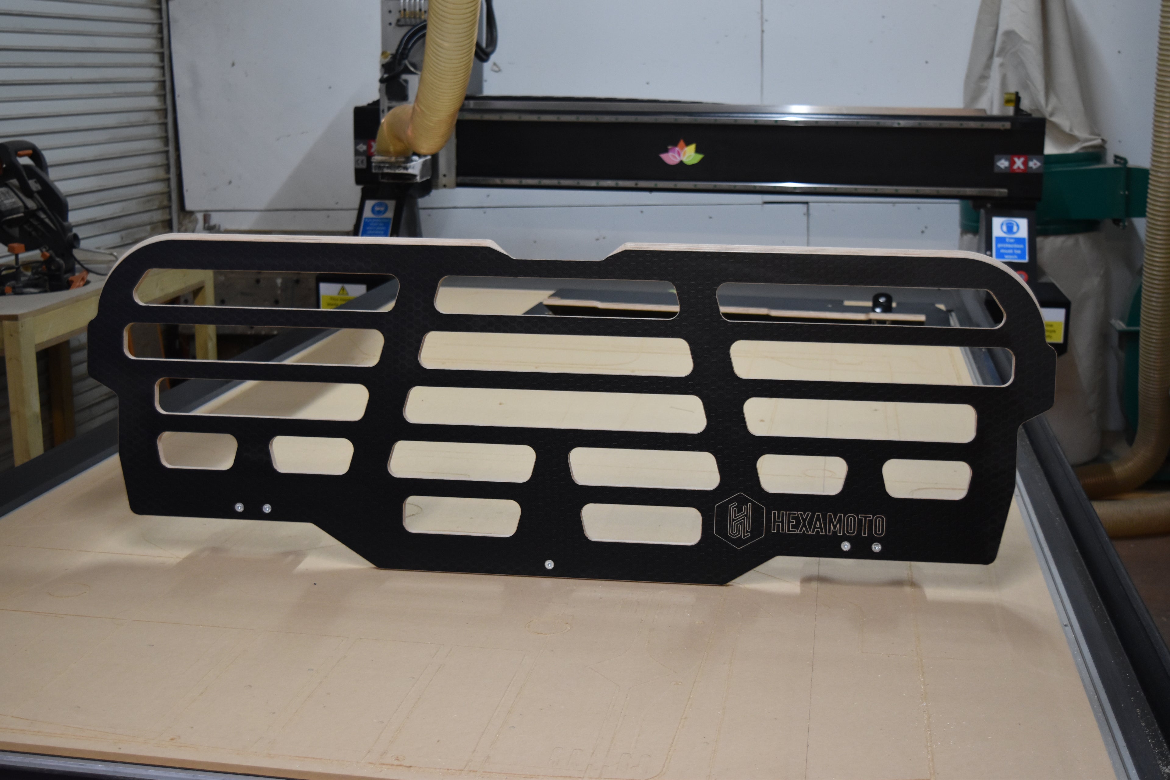 Black wooden Dog Guard from Hexamoto sat on CNC bed for display