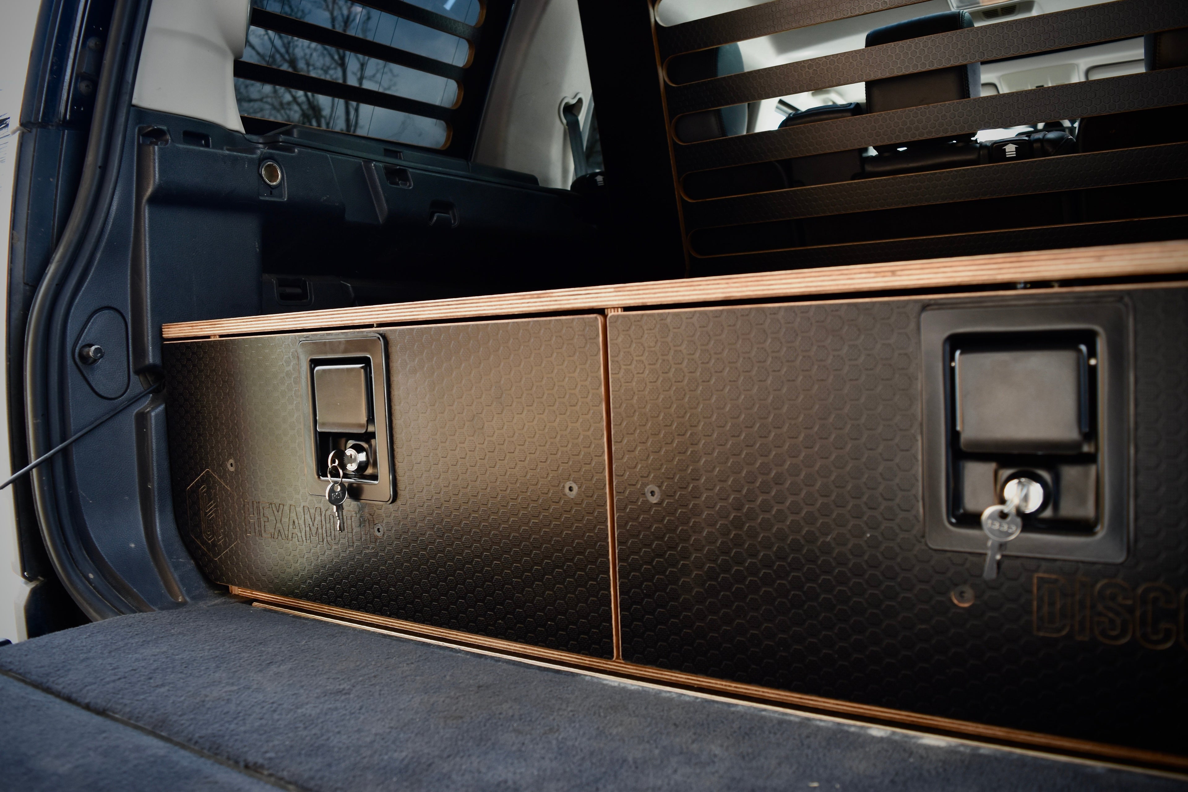 Close-up of a vehicle's open cargo area with storage compartments.