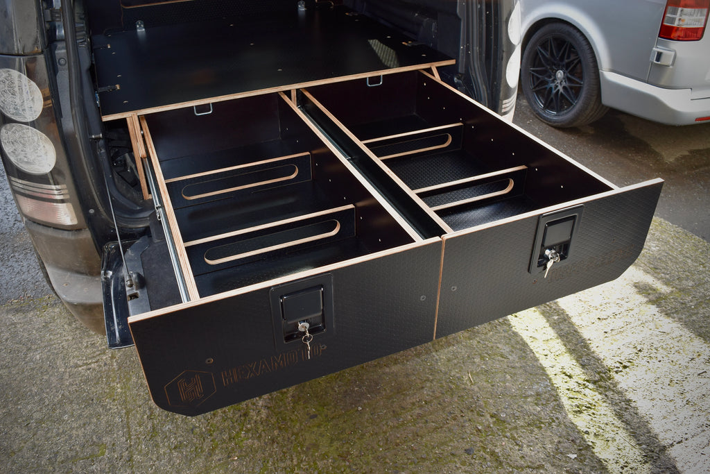 Black wooden drawers pulled out the boot of a vehicle, labelled Hexamoto Disco Sleeper