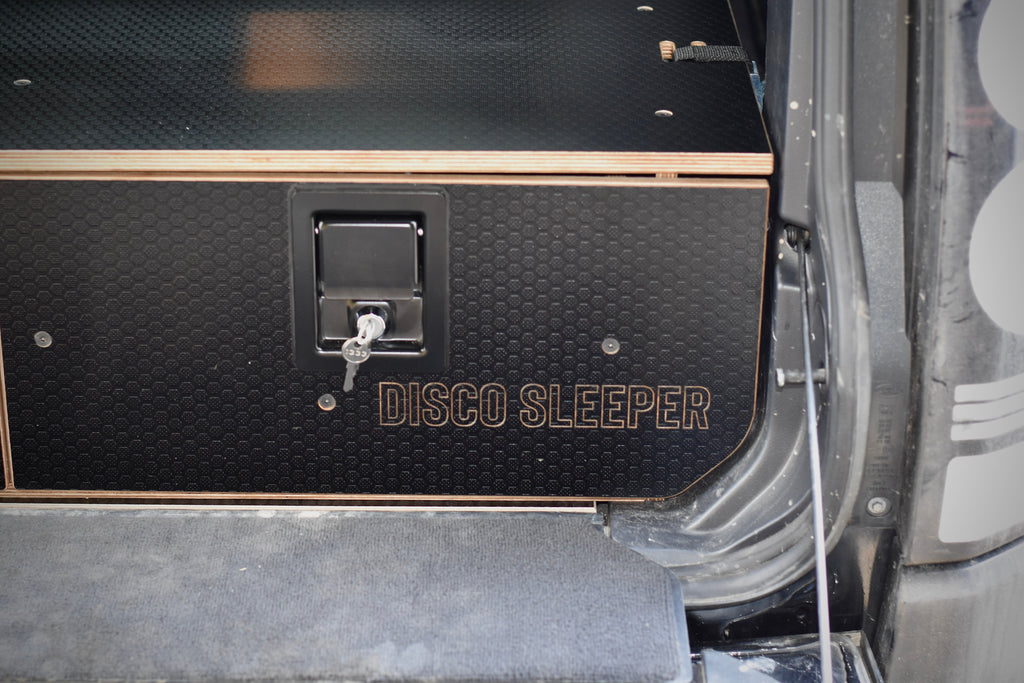 Black storage compartment with 'Disco Sleeper' branding on a vehicle.