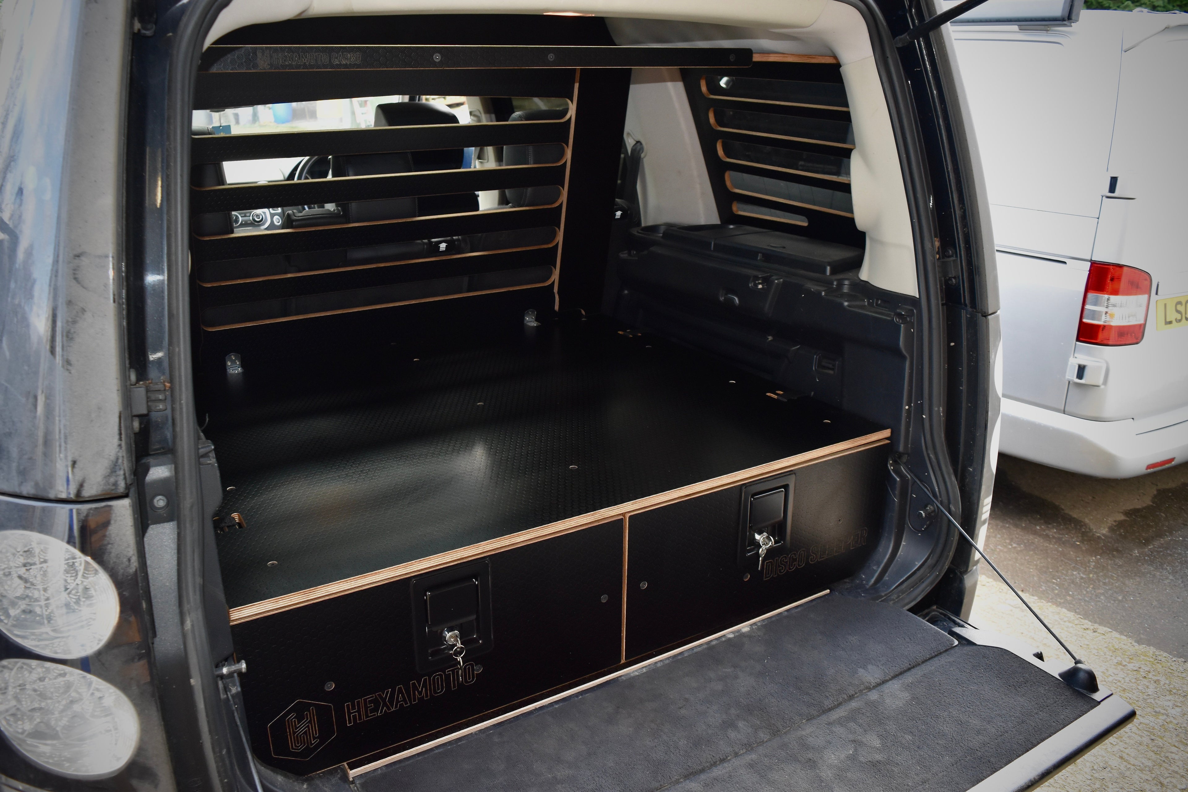 Discovery 4 interior with storage drawers and an upright cargo guard with overhead storage