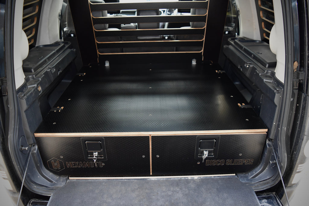Vehicle boot showing custom storage system made by Hexamoto called 'Disco Sleeper'