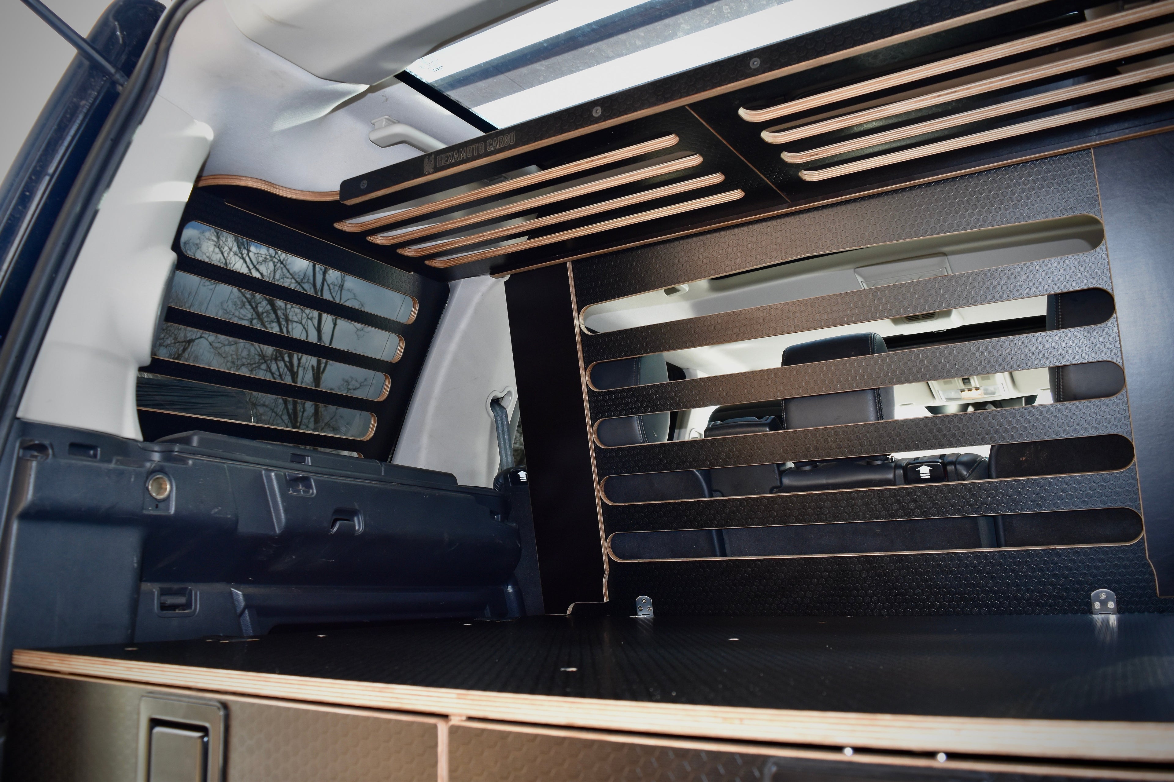 Car interior with wooden storage racks and storage compartments