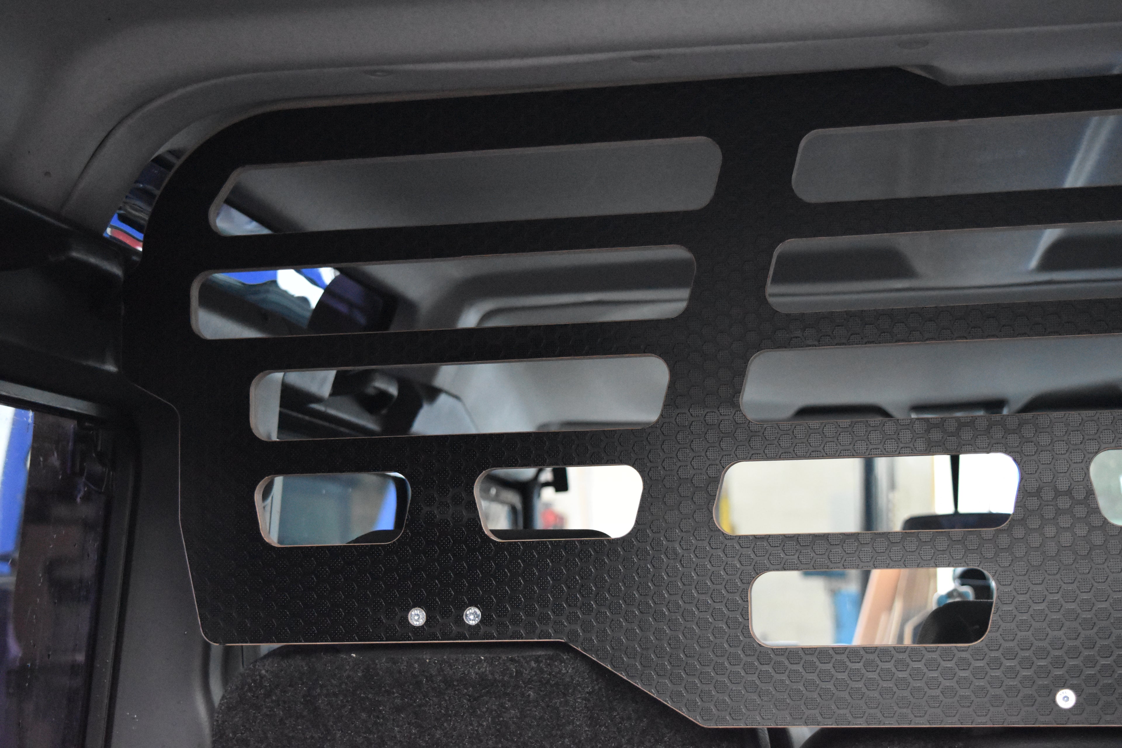 Black wooden Dog Guard from Hexamoto fitted in a Defender 110 Stationwagon