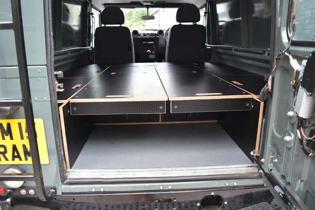 Defender interior with bed platform collapsed and storage compartments closed