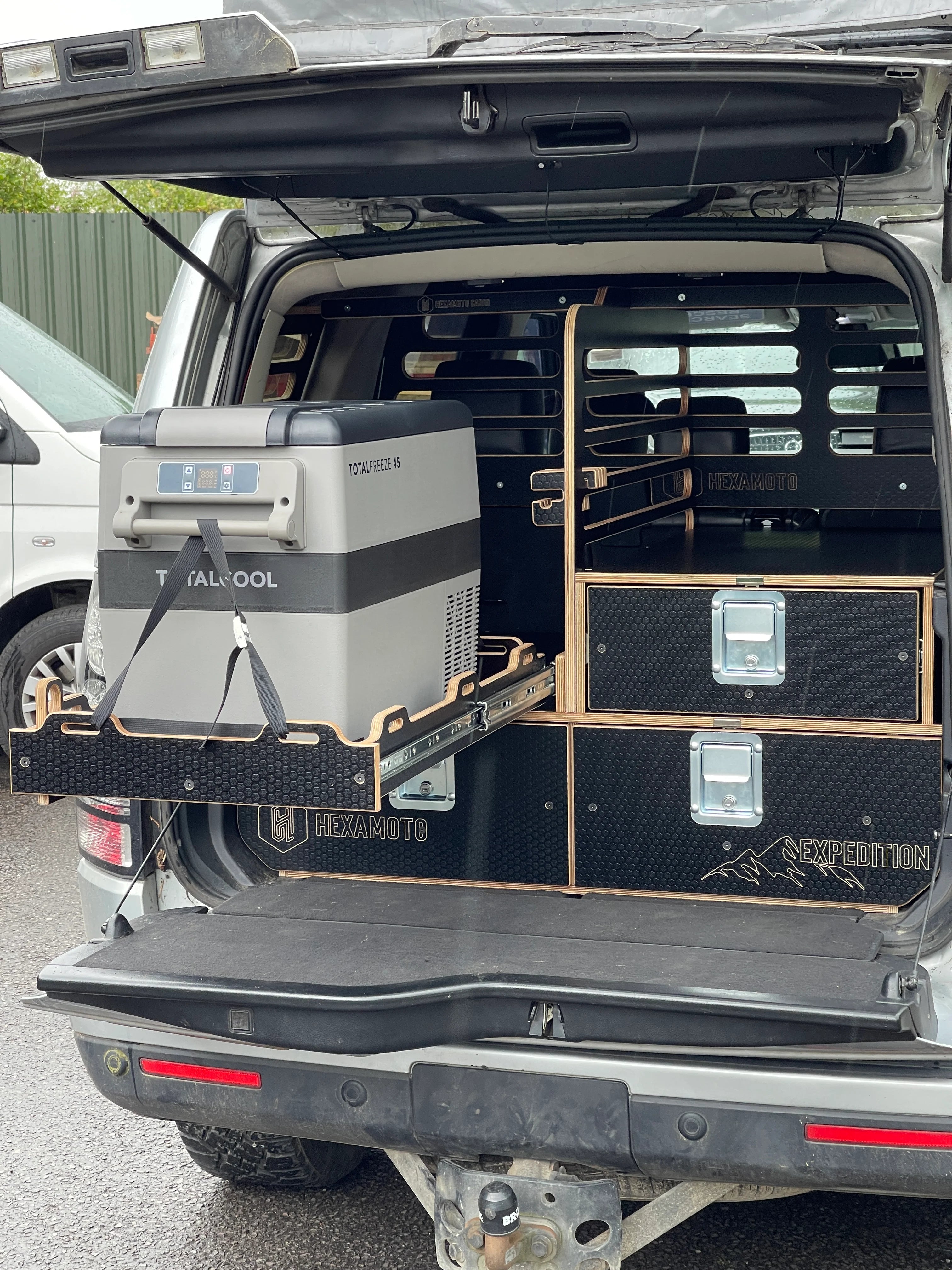 Trunk of a vehicle with storage drawers and equipment