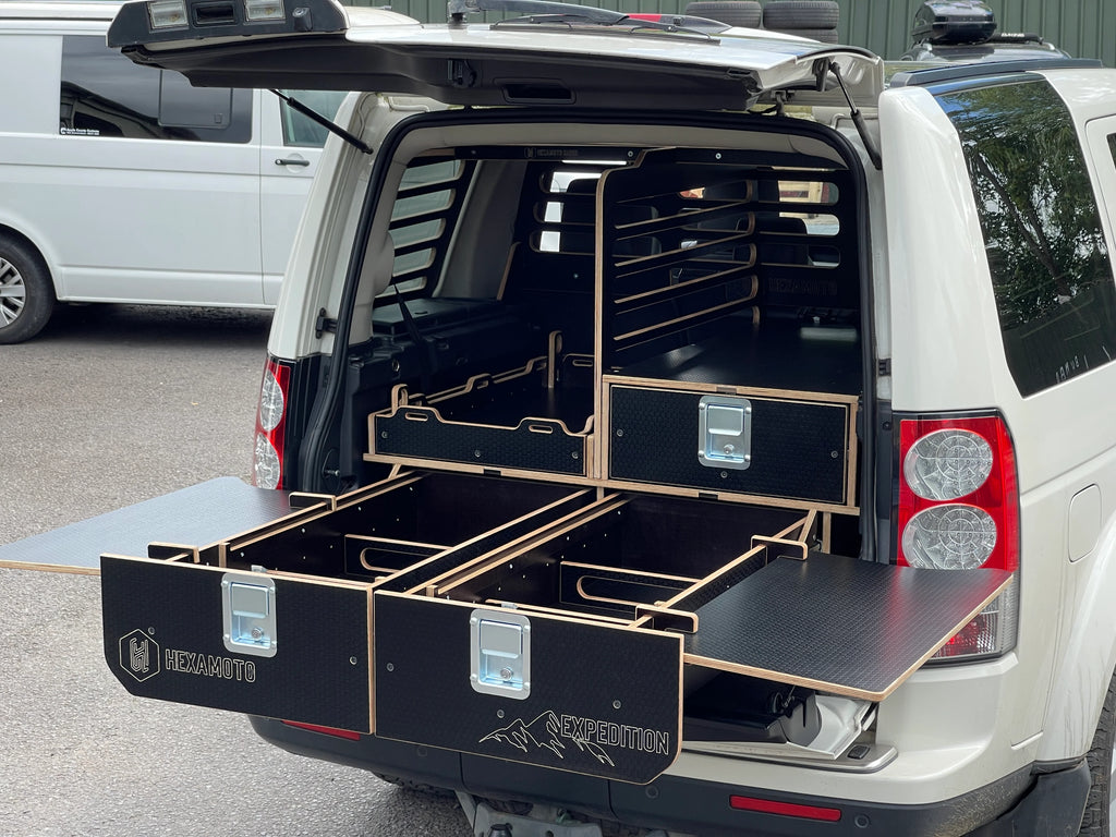 Car boot with a black storage system with tables fitted to the sides