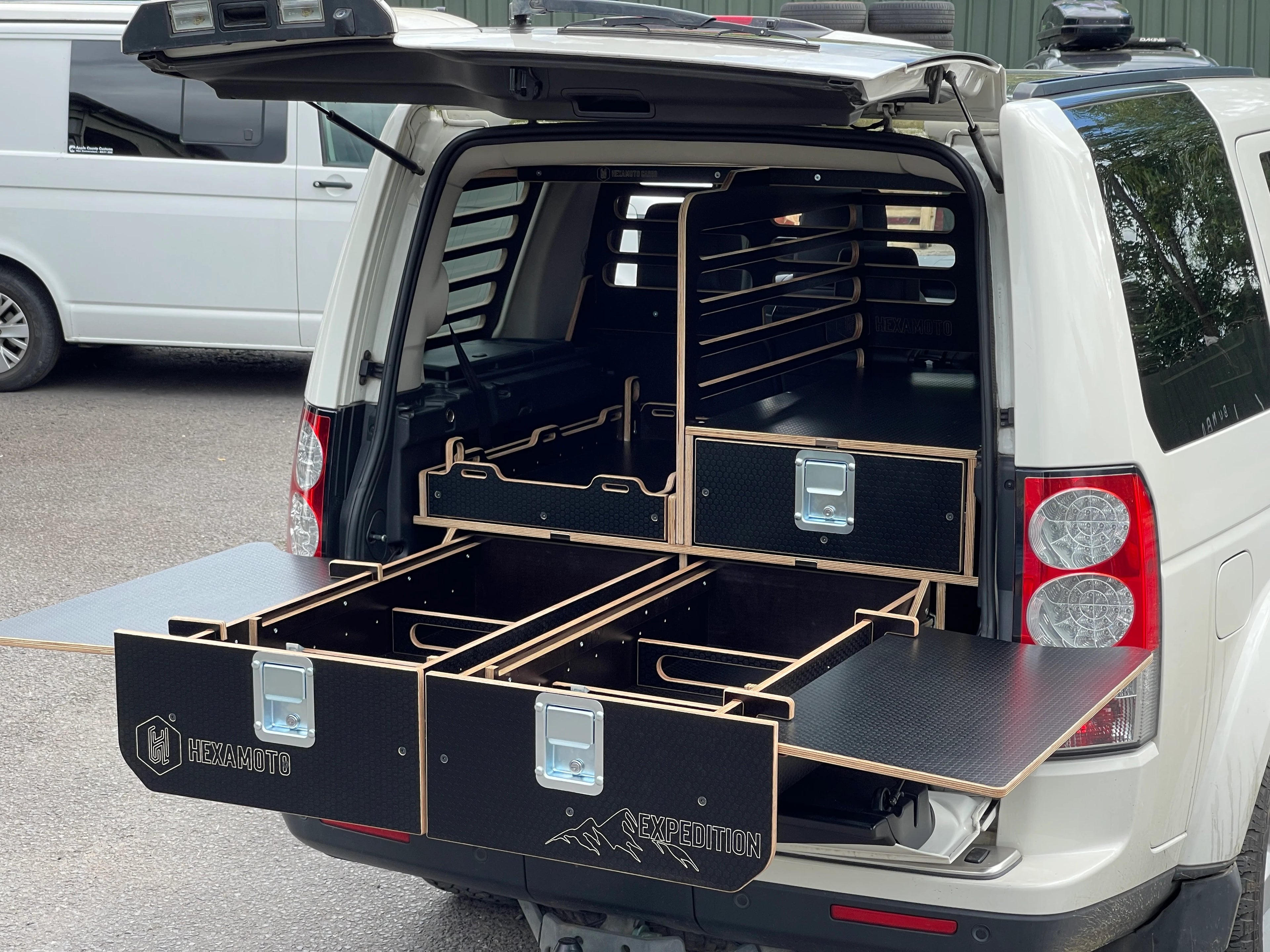 Car boot with a black storage system with tables fitted to the sides