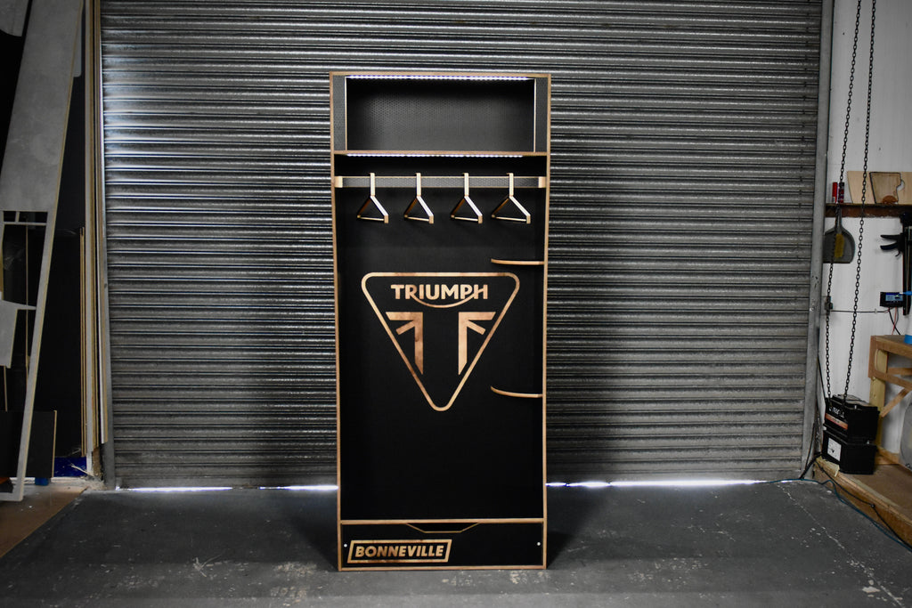 Black cabinet with Triumph Bonneville logo in a garage setting