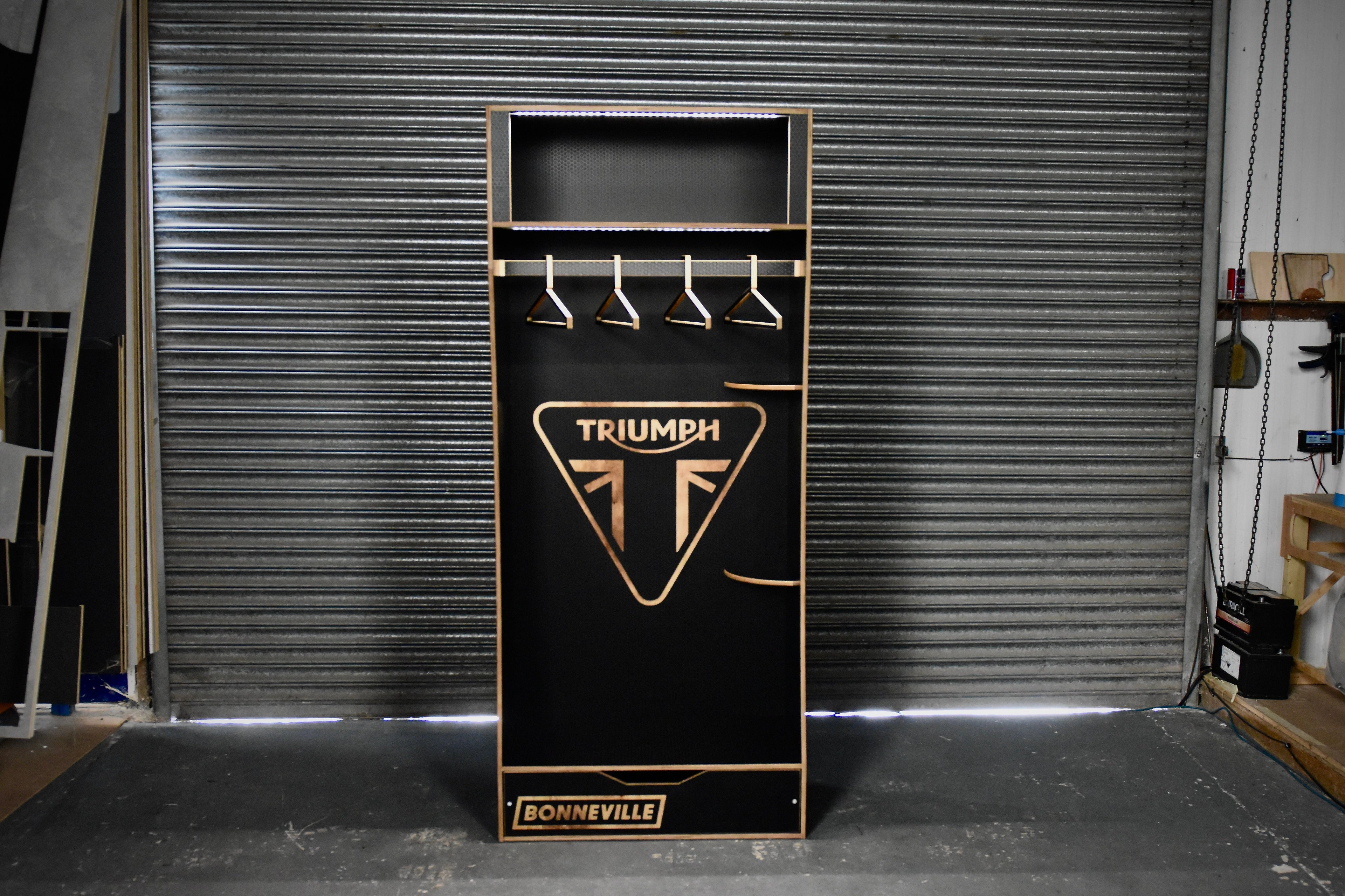 Black cabinet with Triumph Bonneville logo in a garage setting
