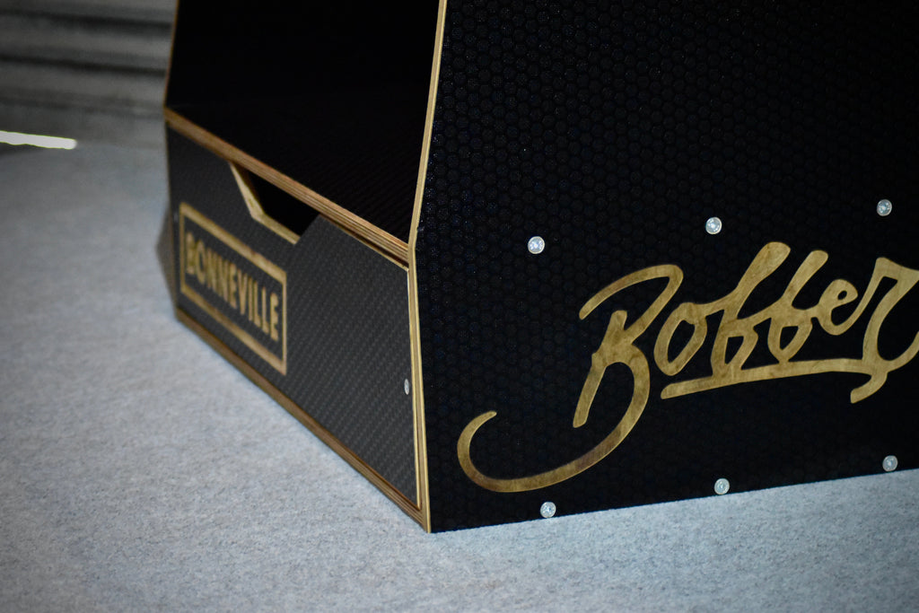 Black wooden storage system with 'Bonneville' and 'Bobber' branding on a hexagon detailed surface