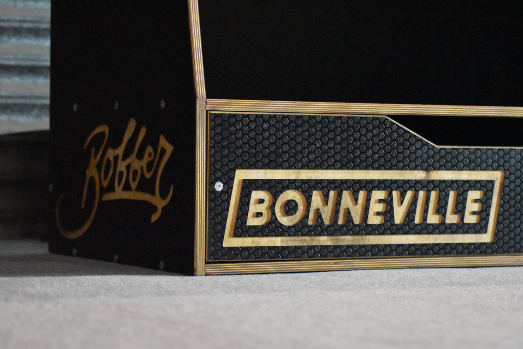 Bonneville logo on a motorvike clothing storage system with Bobber logo to the side of the system 