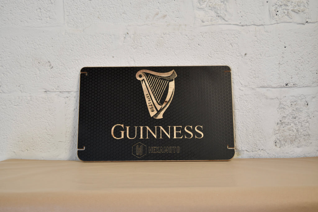 Guinness table with logo on a white brick wall background