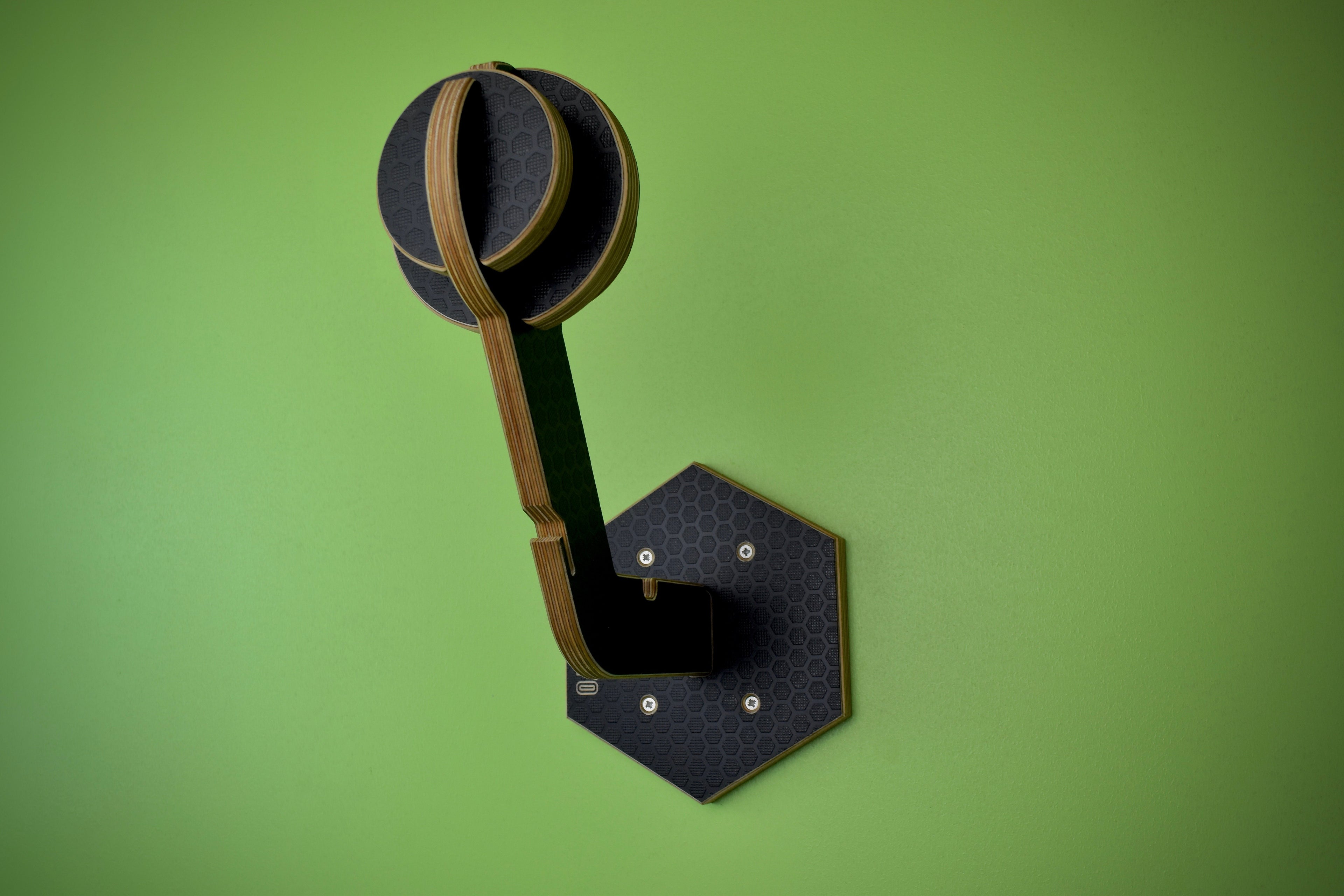 Hexamoto Mini helmet and clothing stand on a green background