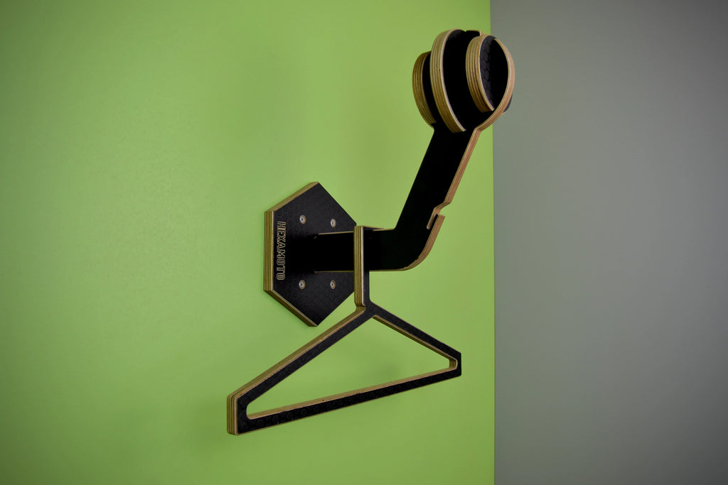 Hexamoto Mini mounted to wall featuring it's geometric design on a green and gray background