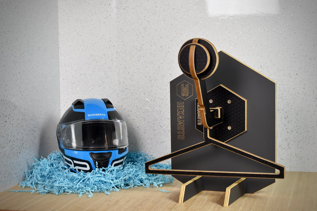 Motorcycle helmet on a Hexamoto Mini with decorative elements on a wooden surface.