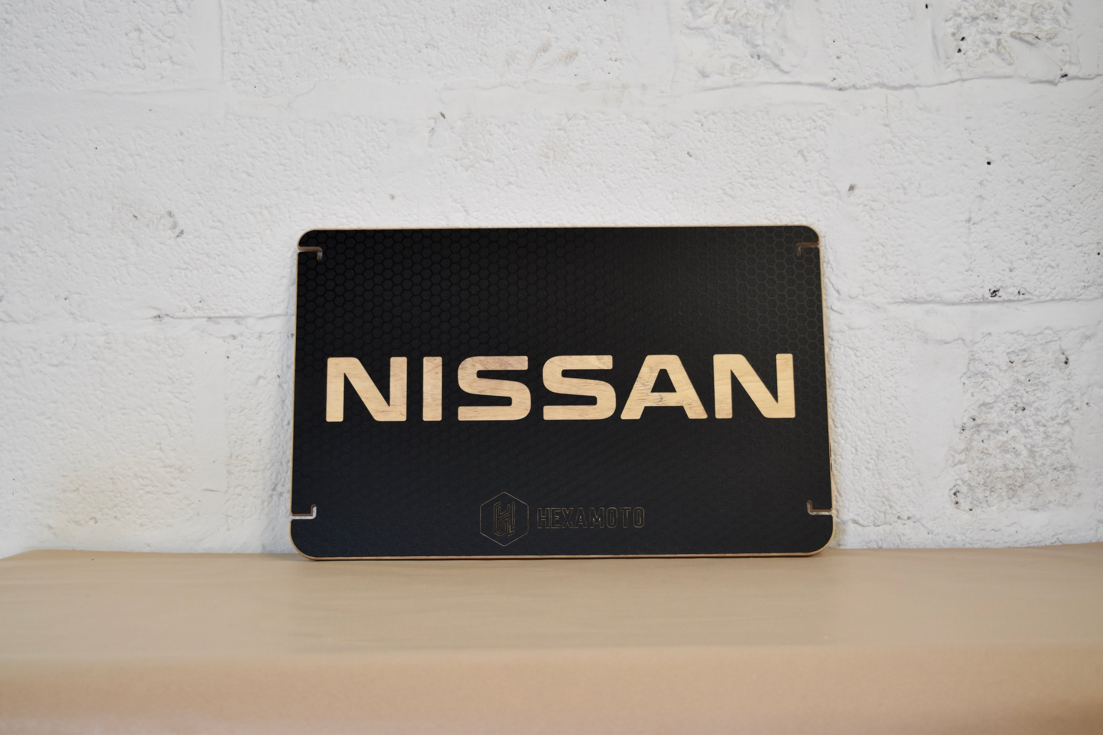 Black Nissan table on a white brick wall background