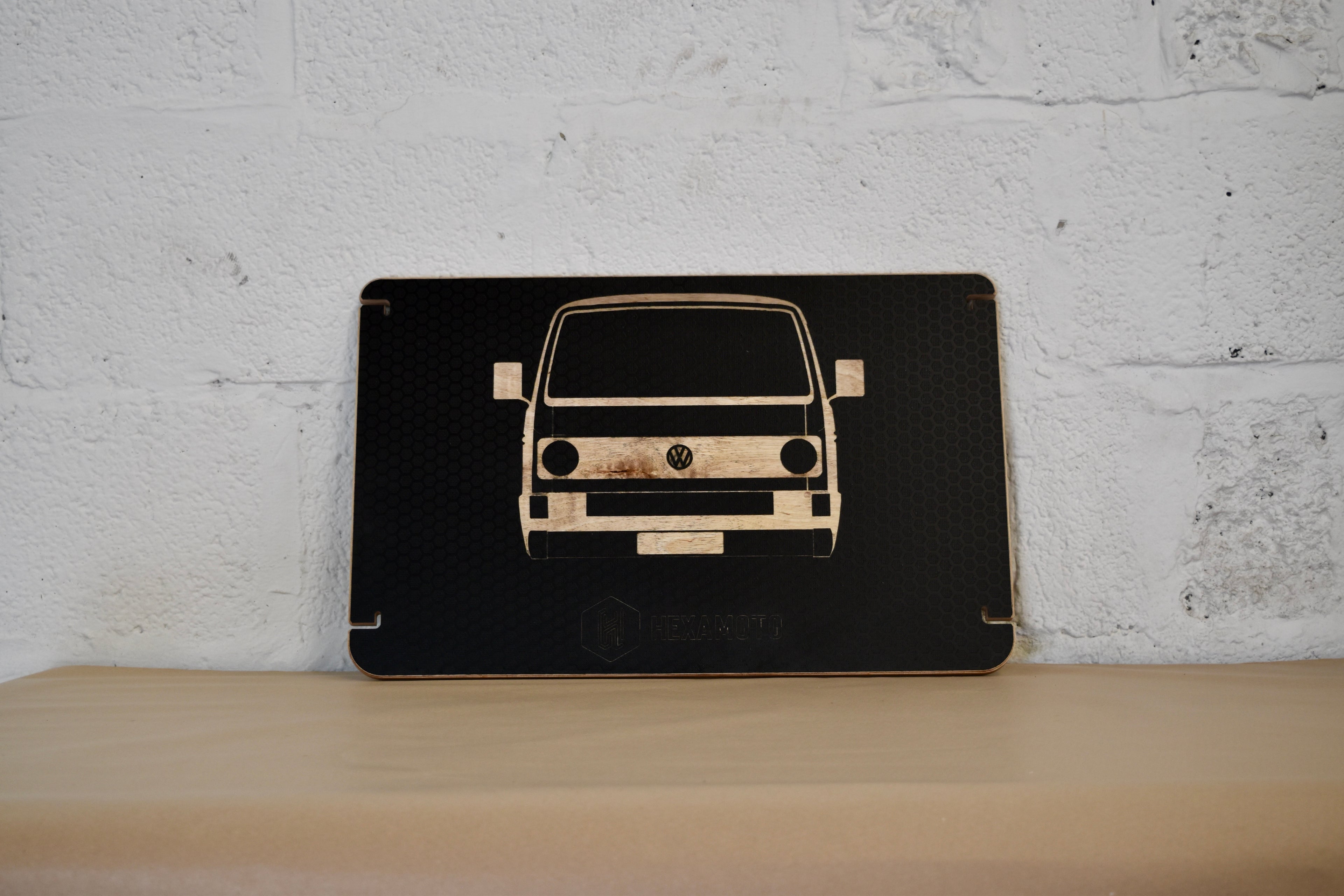 Wooden table with a car design on a white brick wall background