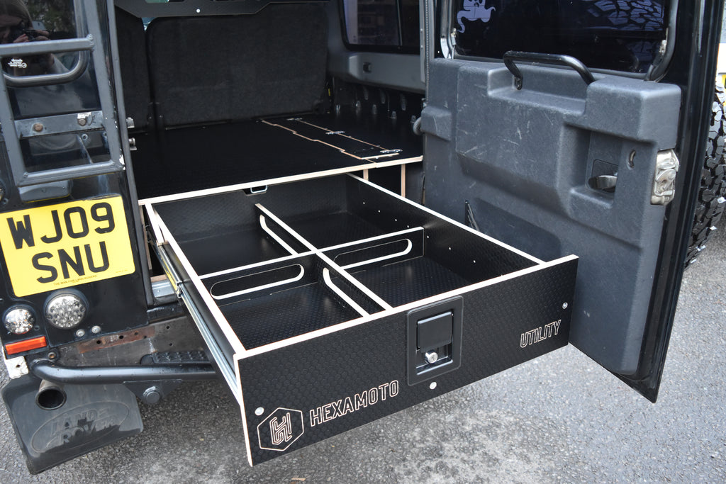 Hexamoto Defender rear storage system with open drawers on a Defender 110