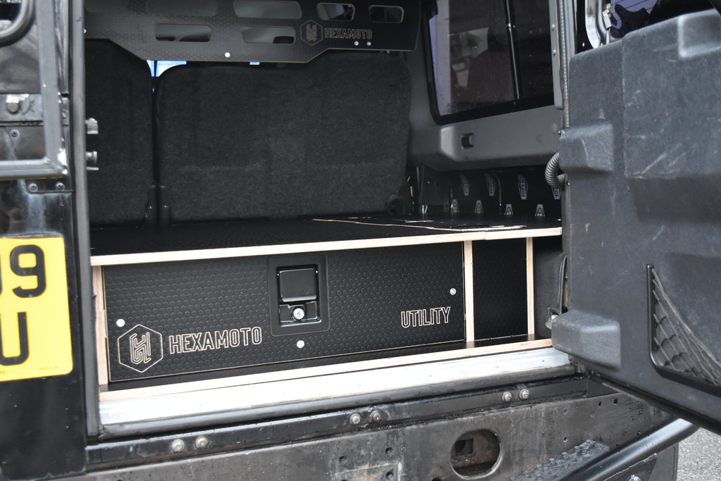 Hexamoto Utility vehicle interior storage system with storage compartments and branding.
