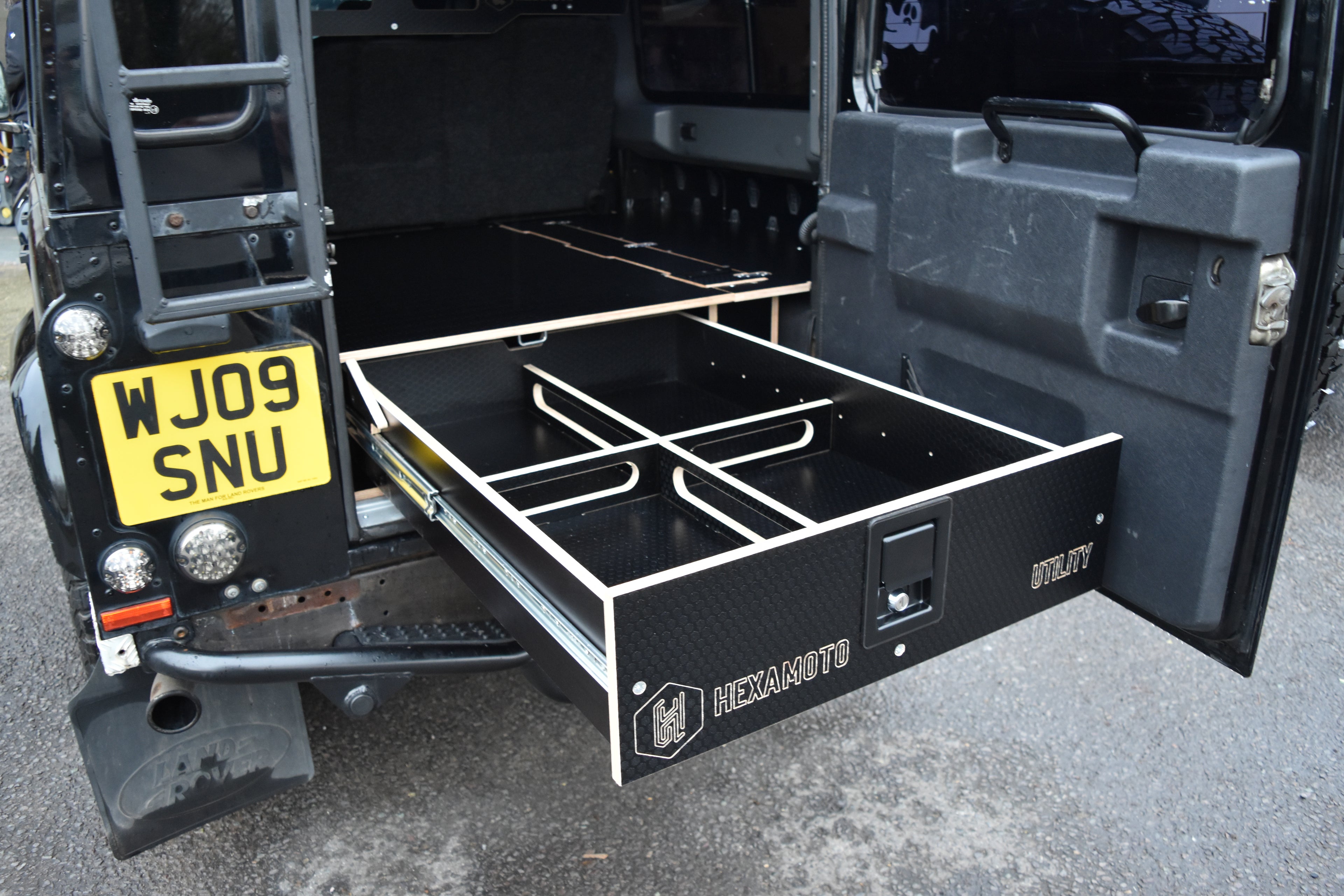 Open storage drawer on a Defender 110 sporting the Hexamoto Utility System