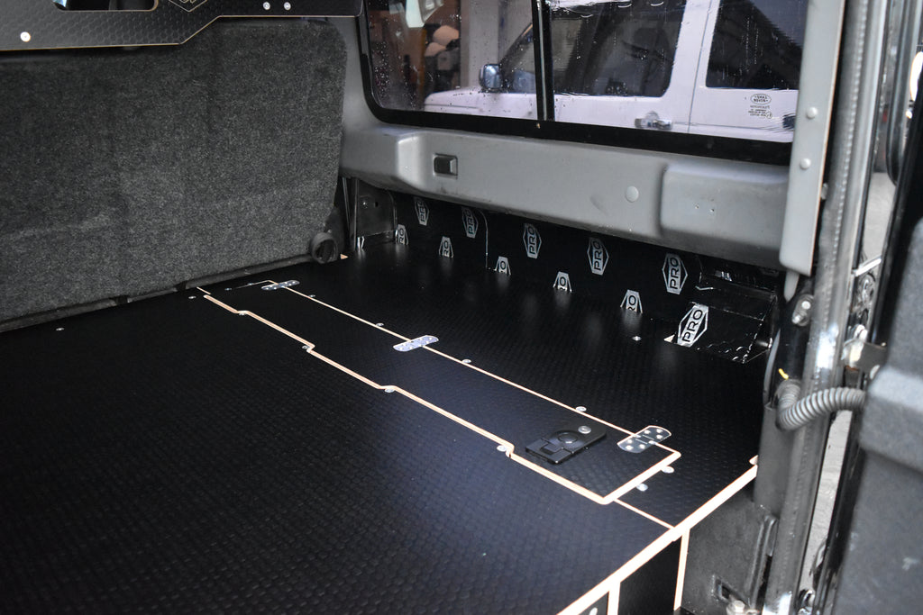 Black wooden storage system in Defender 110 with top cubby hole 