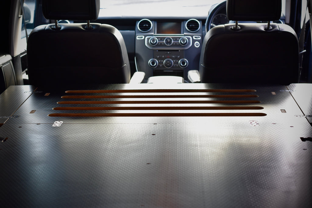 Car interior showing the Disco Sleeper bed platform, made by Hexamoto 