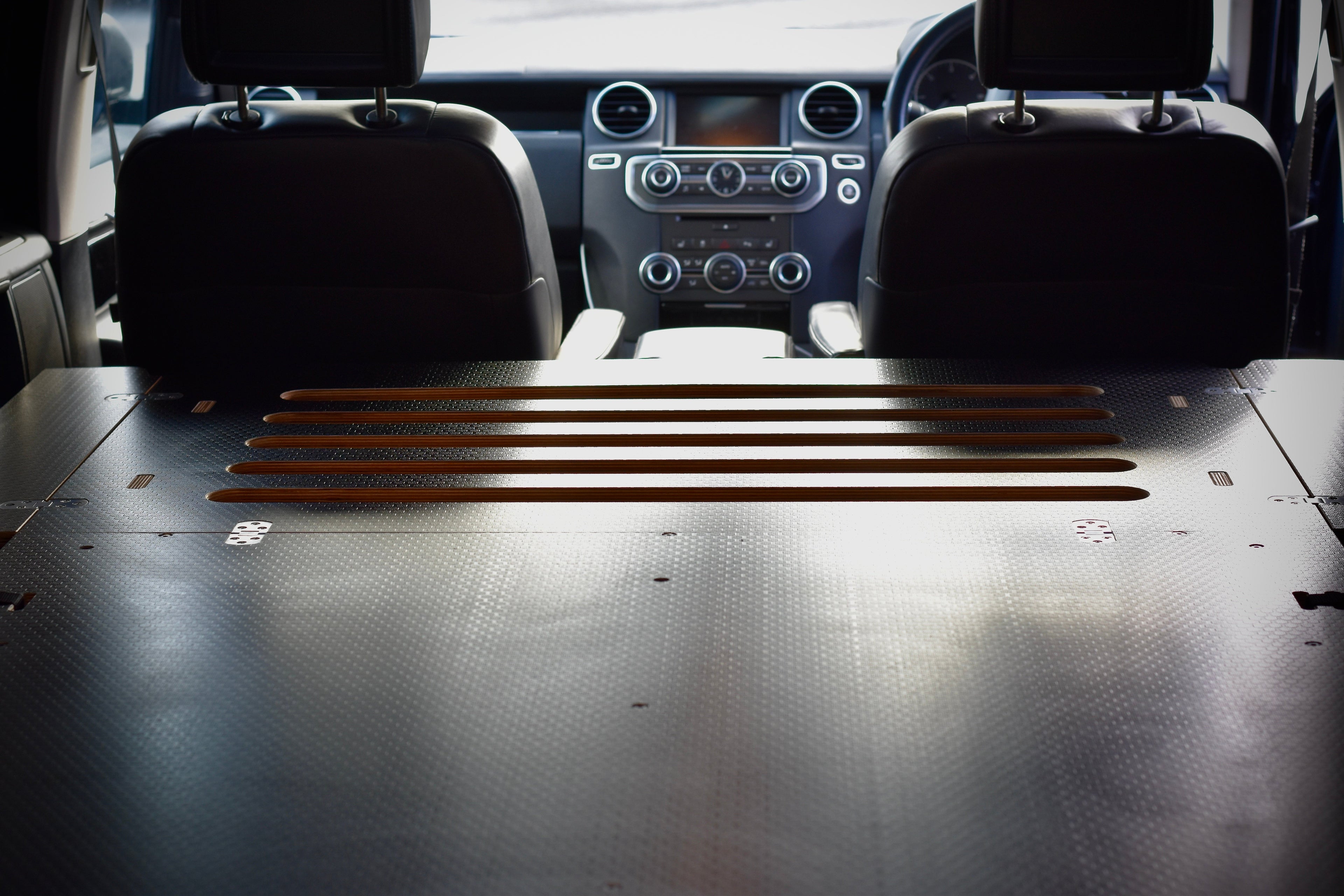 Car interior showing the Disco Sleeper bed platform, made by Hexamoto 