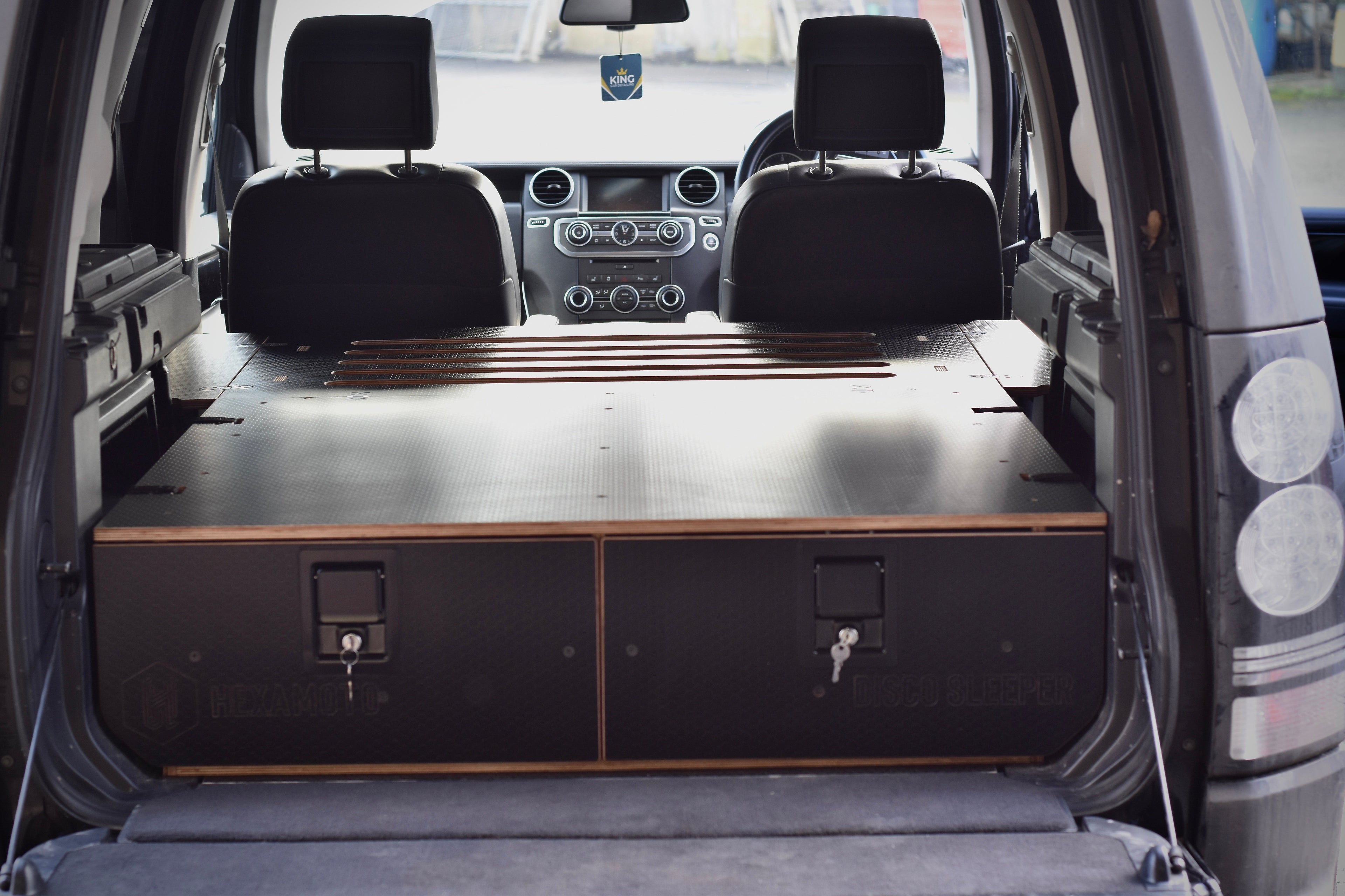 Car interior with flat bed platform for sleeping
