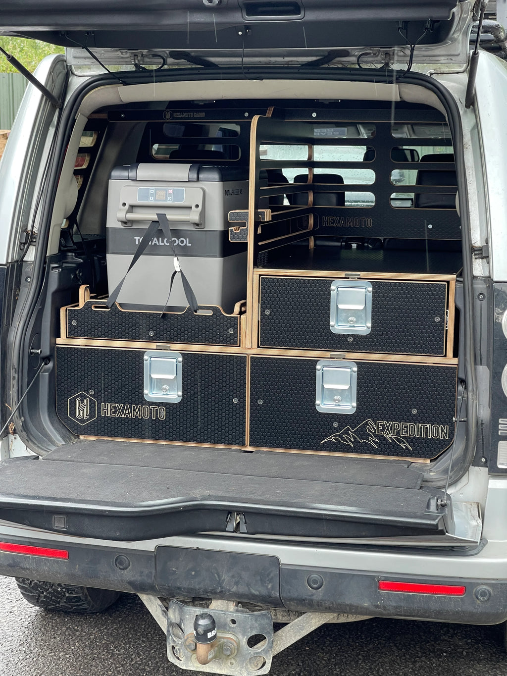 Boot of a vehicle with storage compartments and equipment