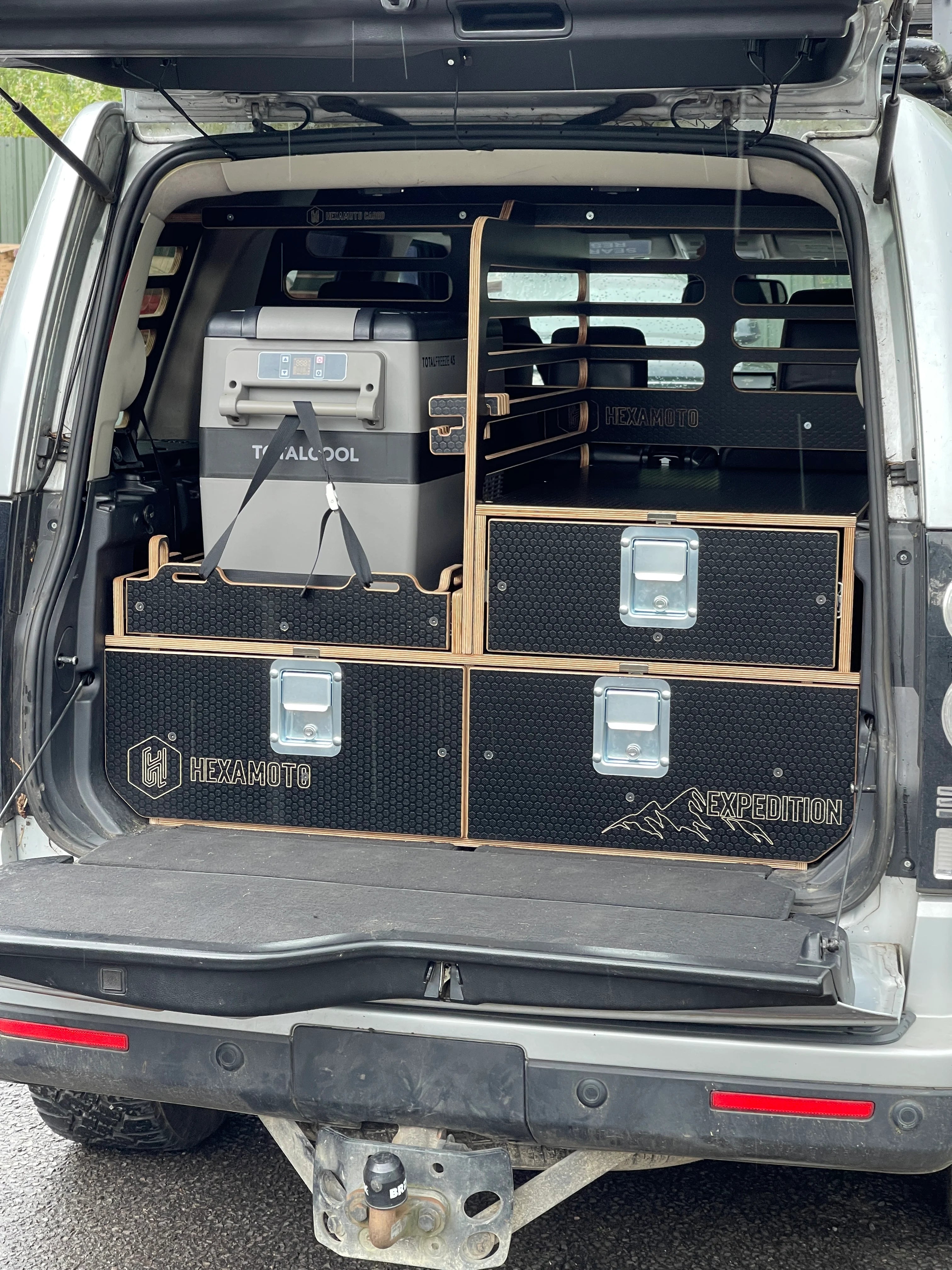 Boot of a vehicle with storage compartments and equipment